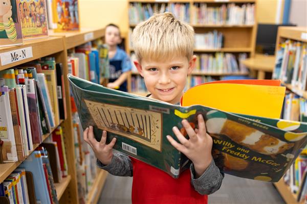 Student with books inside the library
